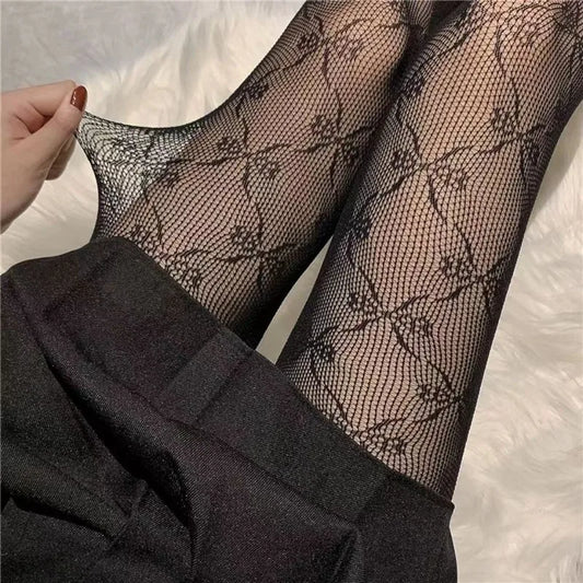 Experience ultimate sensuality with our Sexy Bowknot Black and White Fishnet Nylon Tights!